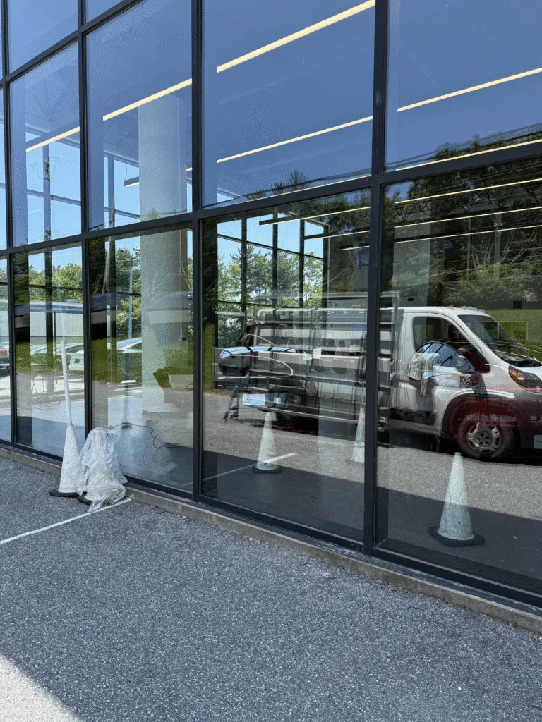 Commercial storefront glass wall with the American Glass van on site