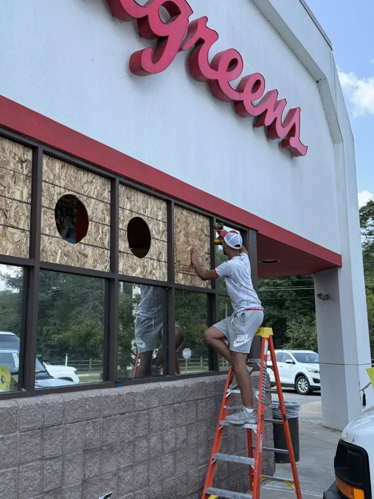 Emergency Glass Repair: Man boards up Walgreens windows with plywood after damage | American Glass and Door