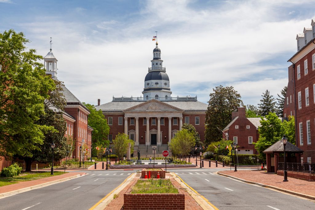 Maryland State House in Annapolis is a historic building with a dome, seen from street level, showcasing its architectural details | American Glass and Door