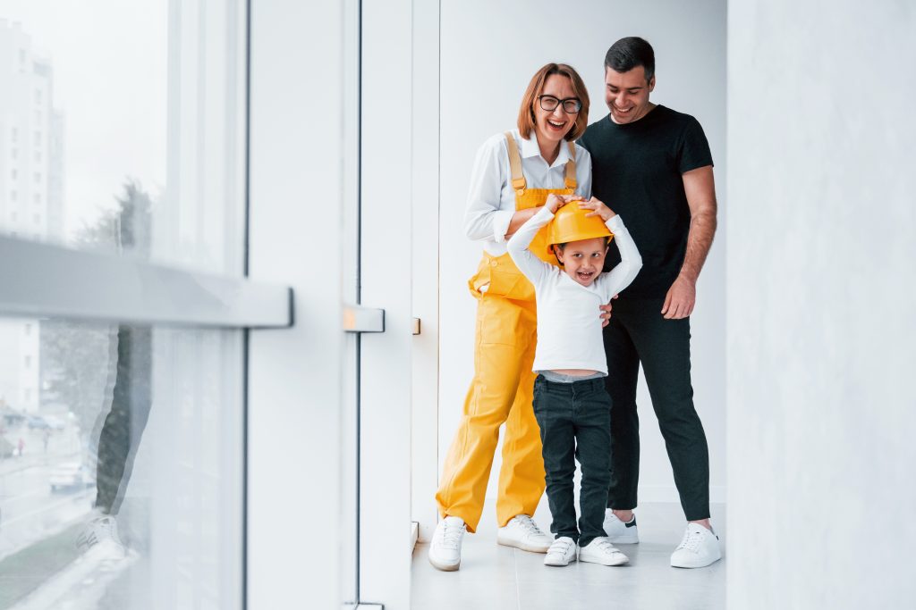 Family wearing construction attire, showcasing Commercial Door Replacement benefits and safety for your business | American Glass and Door